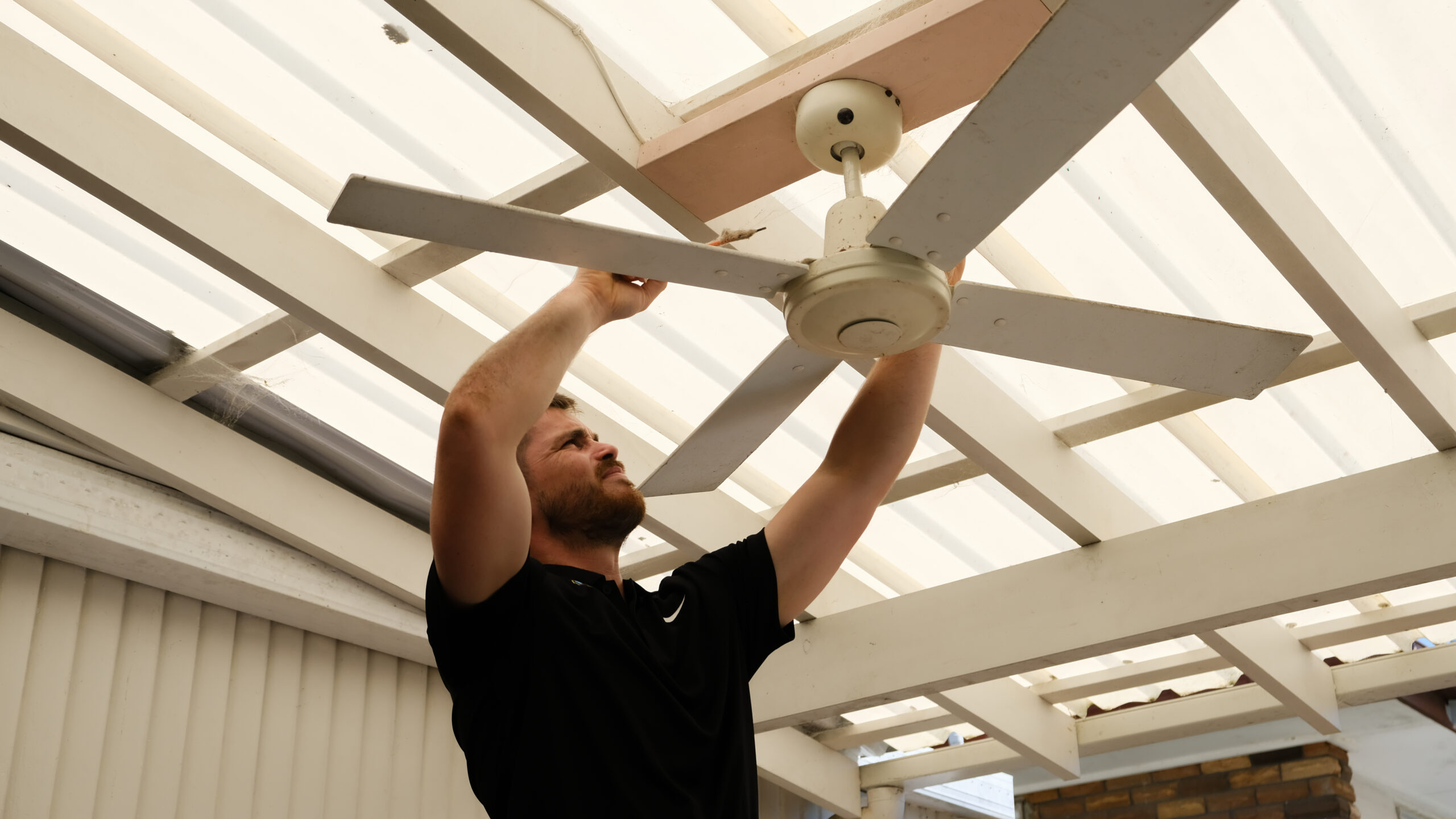 Mr Glow Electrical installing ceiling fan.